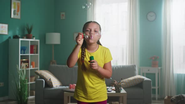 Girl Is Blowing Bubbles at Home