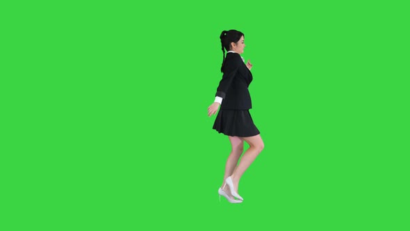 Dancing Brunette Businesswoman Walking In, Stops in the Middle and Then Goes Away on a Green Screen