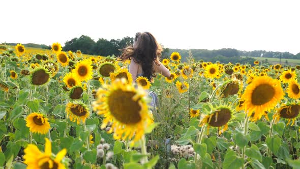 Side View of Carefree Girl Running Through Sunflower Field