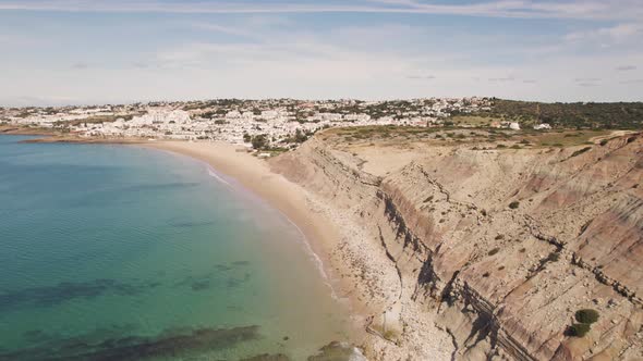 Steep Limestone cliff bordering Praia da Luz along Algarve Coast - Aerial