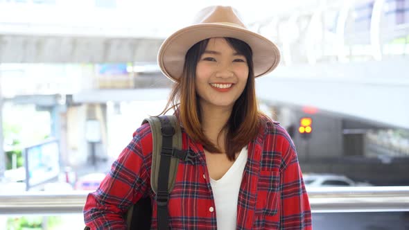 Attractive young smiling Asian woman outdoors portrait in the city real people series.