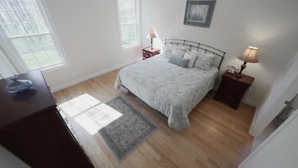 Contemporary Minimalist Bedroom Interior - Bed With Sleek Headboard On A Wood Accent Flooring Agains