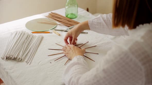 Mature Woman Making Paper Vine Basket at Home