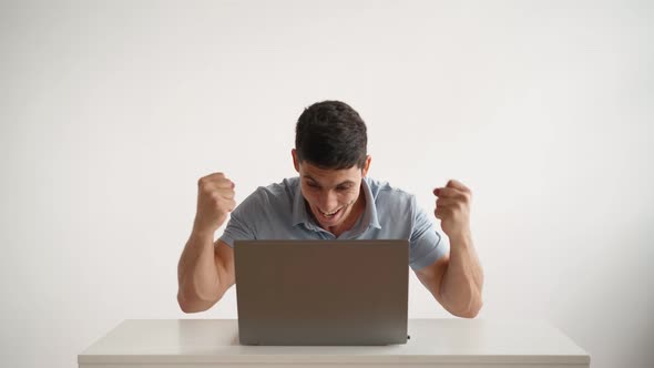 Happy Office Worker Works at Laptop and Funny Rejoices at Successful Deal