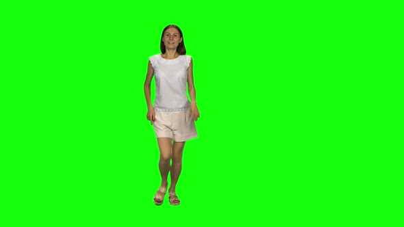 Young Woman with Brown Hair and Smooth Haircut Is Running and Waving Hand Stop on Green Screen