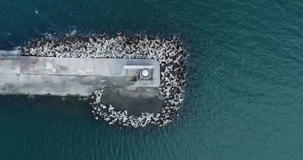 Top down view of lighthouse of Varna, Bulgaria. Motor boat passing.