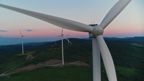 Beautiful Sunset Above Working Windmills on Field