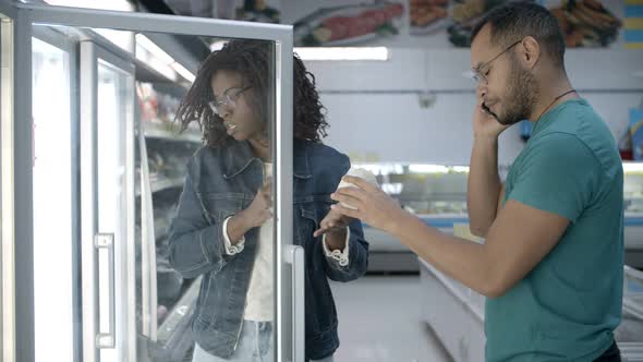 Modern Young Couple Shopping Together at Grocery Store