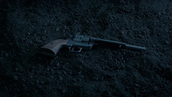 Six Shooter Gun On The Ground In The Evening