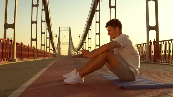 Guy Is Texting After Intensive Workout