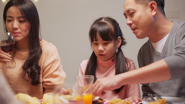 Asian young family feel happy enjoy having birthday party for young little child together at home