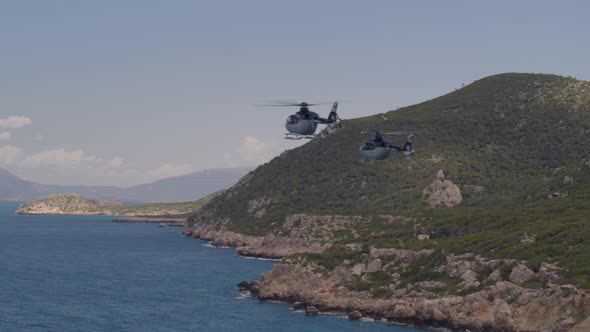 Private Helicopters Flying Over Ionian Sea and by Cliffs Cascading into Water