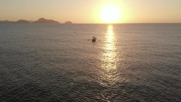 Aerial view of outrigger Boat during sunset in El Nido