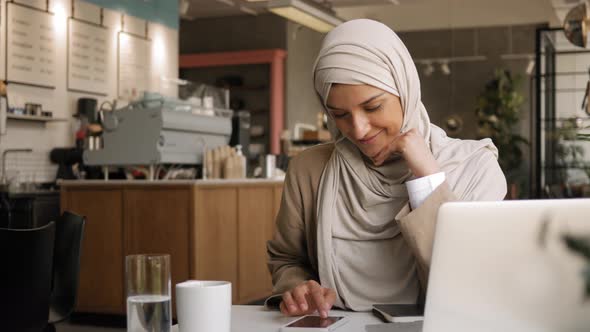 Muslim Woman on Remote Working Online Education or Video Conversation in Caffe