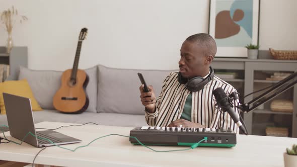African Artist Playing Midi Synthesizer while Having Video Conversation