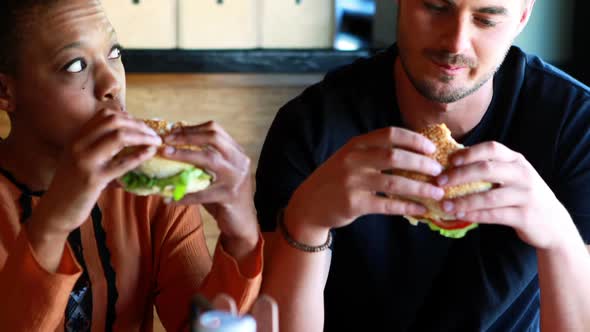 Happy couple eating burger