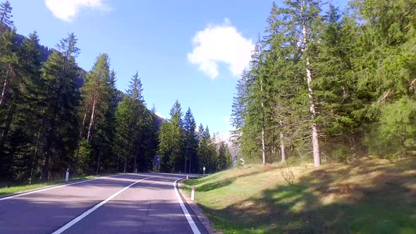 Driving car on the winding roads in the Dolomites in early spring, Alps