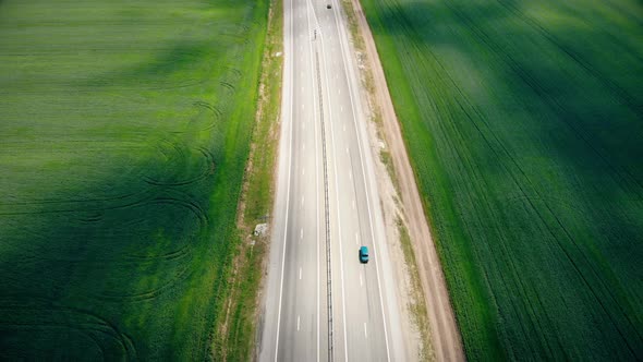 Aerial Flight Over the Road Between Fields. Summer Colors