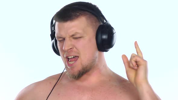 Man Listening To Music with Headphones. White. Slow Motion