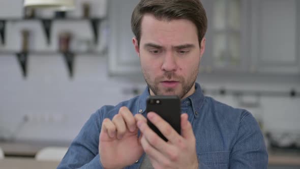 Portrait of Beard Young Man Get Shocked on Smartphone