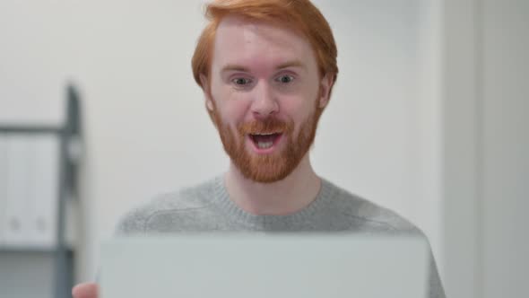 Portrait of Redhead Man Doing Video Chat on Laptop 