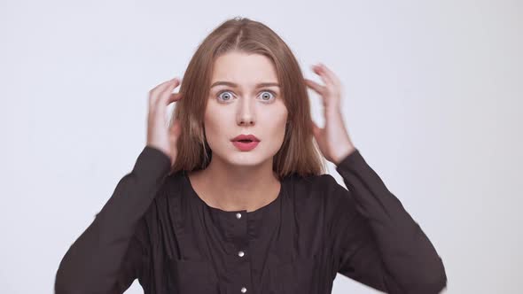 Young Beautiful Shocked Fairhaired Girl Over White Background