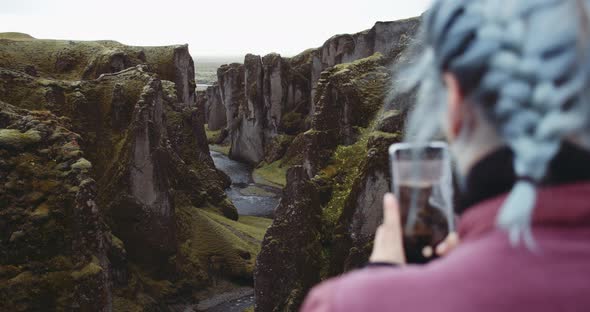 Woman Photographing Fjadrargljufur Canyon With Smart Phone