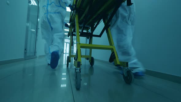 Doctors Move Stretcher in Corridor.