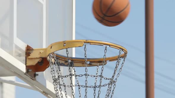 Ball Falls Into A Basket With An Iron Net