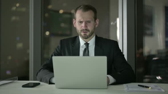 Sleepy Businessman Keep Working on Laptop at Night