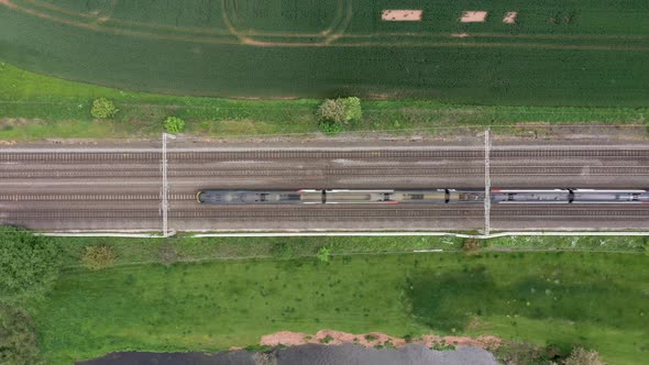 Railway in the countryside and trains passing, aerial view