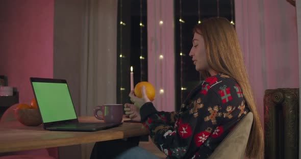 Young Female at Xmas Using Laptop Video Call