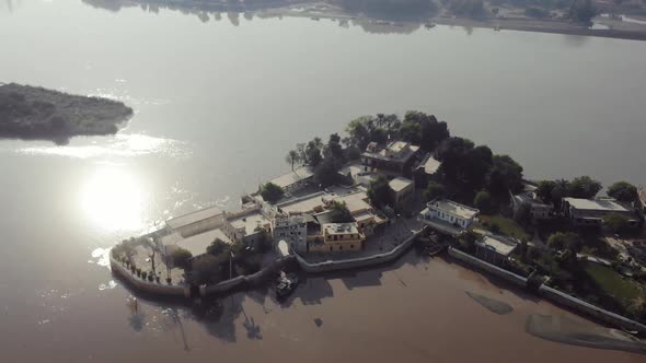 Aerial View Of Sadh Belo Island Temple On The Indus River In Pakistan. Follow Shot