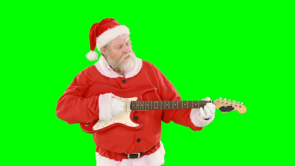 Santa claus singing a song and playing guitar