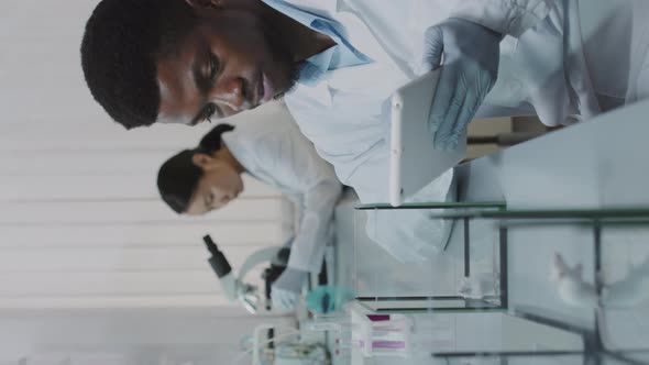 Vertical Shot of Scientist Observing Lab Rats