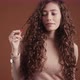 Studio portrait of young woman with long curly hair - VideoHive Item for Sale