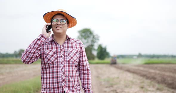 Farmer phone talking at farm have tractor