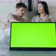 Green Chroma Key Laptop Screen with Happy Couple Having Breakfast in Bed in Background - VideoHive Item for Sale