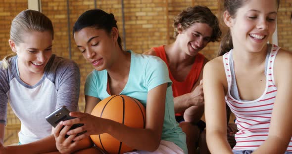 Group of high school kids using mobile phone