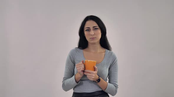 Girl Smiling Holds Cup with Drink