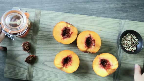 Cutting peaches in half for making grilled peaches.