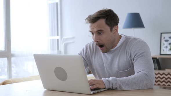 Wondering Adult Man Working on Laptop in Shock