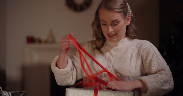 Woman Unpacking Gift at Christmas