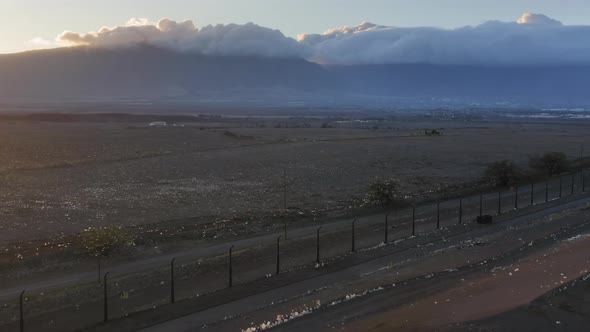 Aerial View of Landfill with Plastic Bags at Sunset Mountains Covered By Clouds