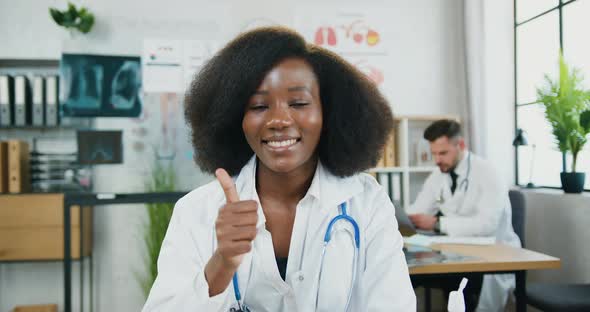 African American Female Doctor in Medical Uniform with Stethoscope Posing on Camera