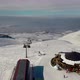 Aerial View Snow Mountain Peak Clouds in Background  Winter Drone Footage Ski Resort - VideoHive Item for Sale
