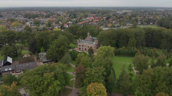 Cinematic aerial of a beautiful old mansion on green estate