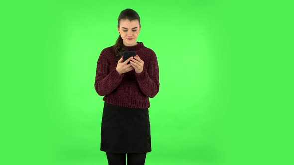 Girl Angrily Texting on Her Phone. Green Screen