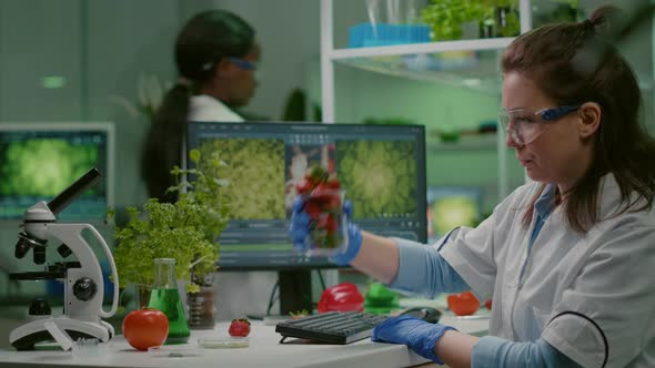 Pharmaceutical Scientist Looking at Glass with Strawberry