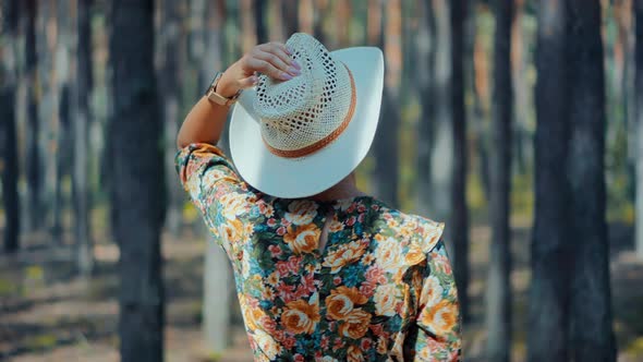 Carefree Relaxing Woman In Hat Walking Pine Forest.Holiday Vacation Tourist Journey Trip In Forest.